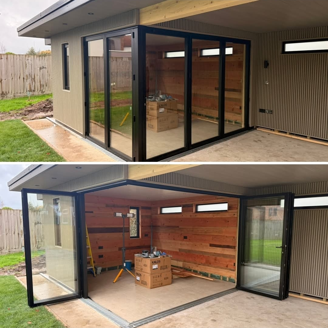 Garden room with full-height anthracite bifold doors and cedar interior cladding