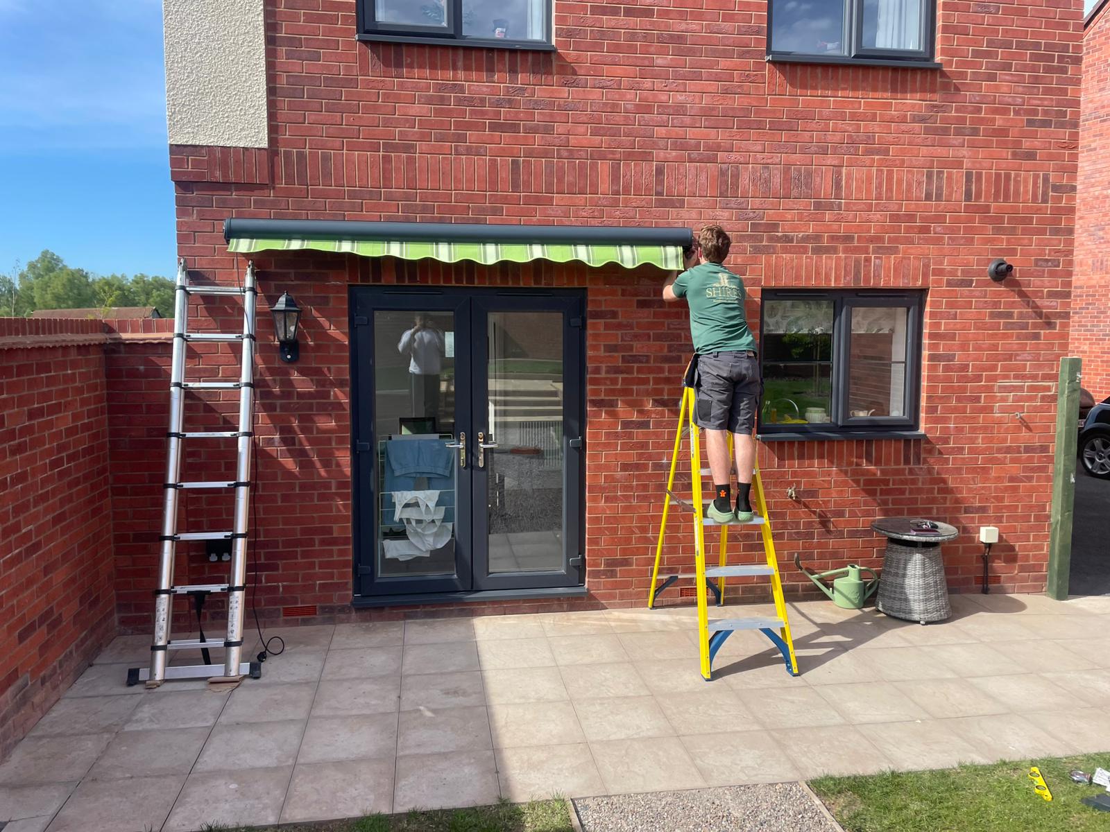 Shires Shutters installation, real fitter green stripe awning