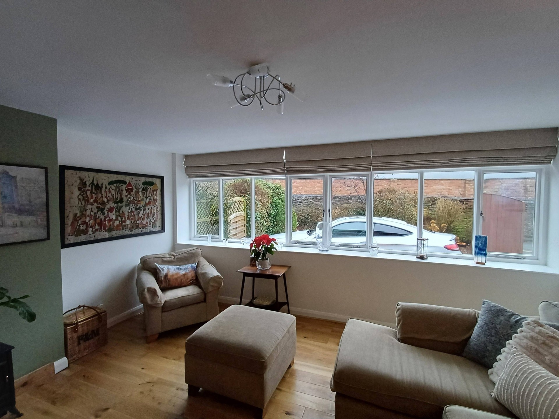 Made-to-measure Roman blinds dressing a living room window by Shires Shutters